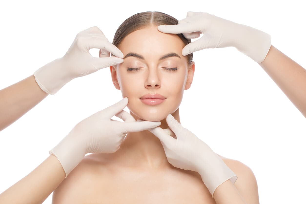 Médico avaliando o rosto de uma mulher após o lifting facial com fios para rejuvenescimento da pele